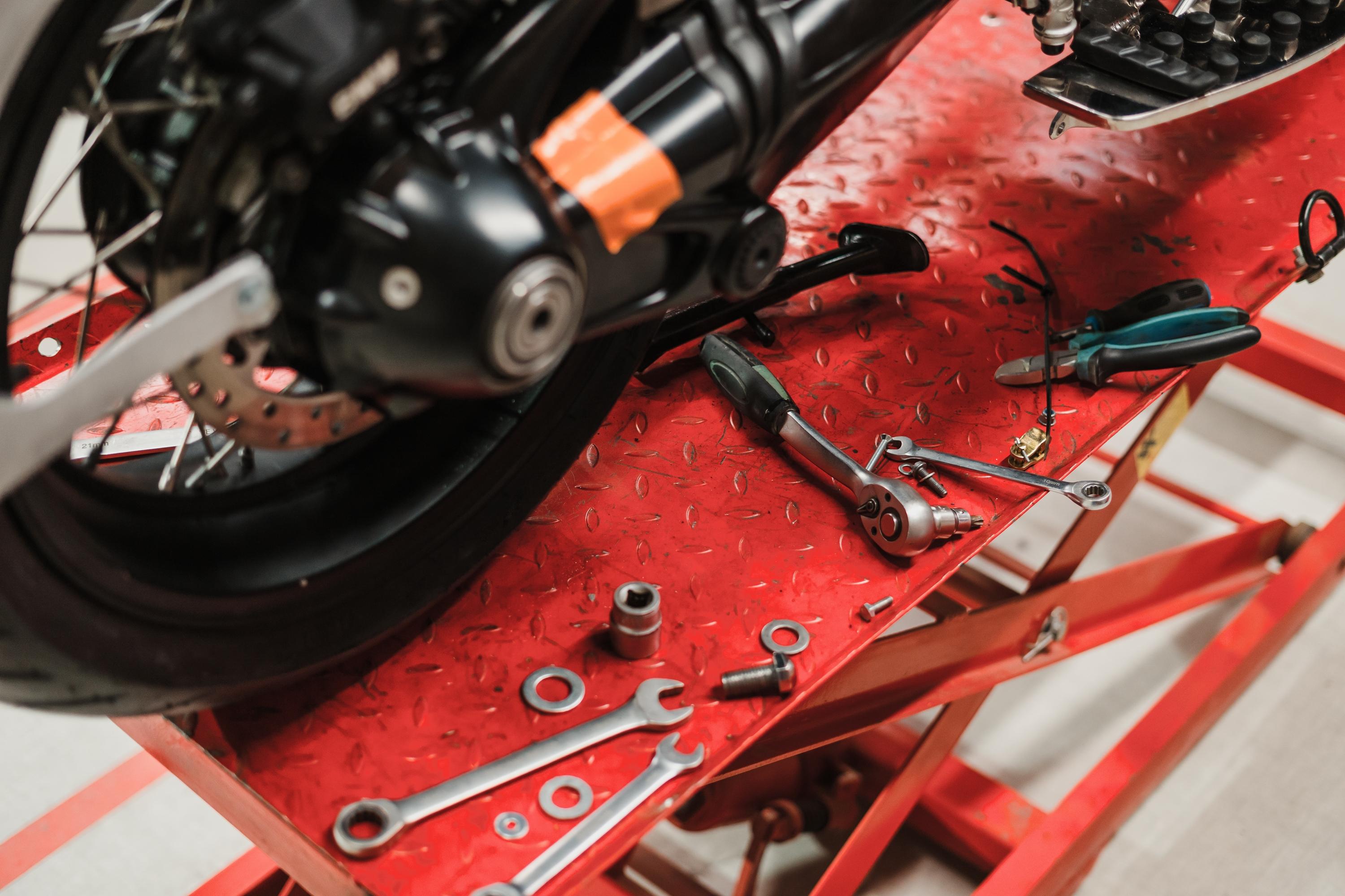Motorcycle repair in a garage service bay