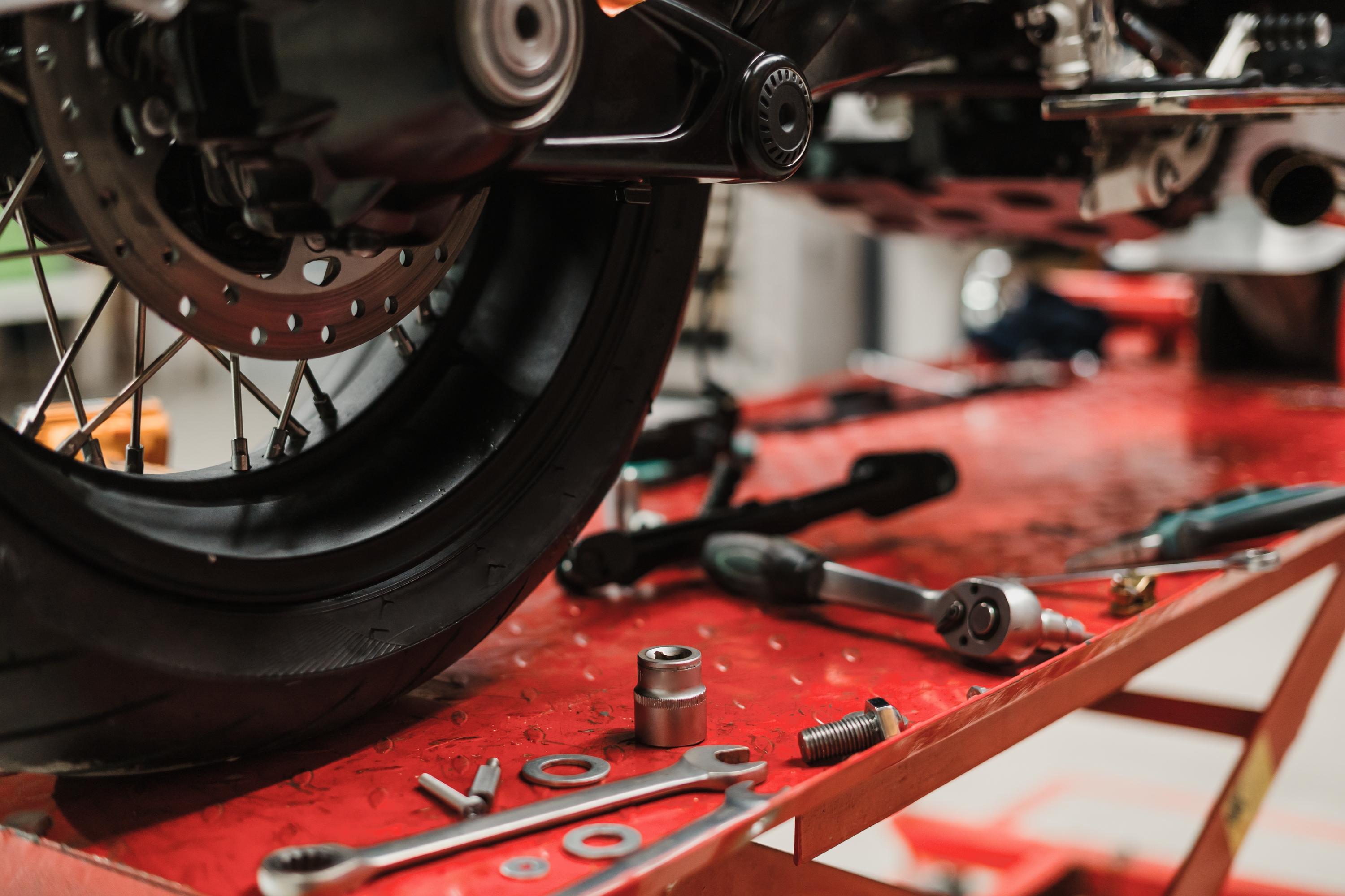 Mechanic inspecting a motorcycle in the garage